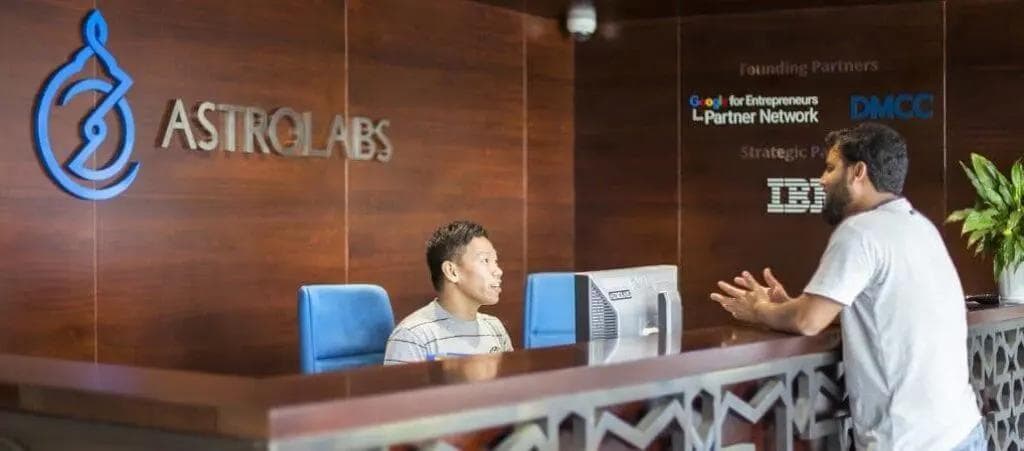 guest talking to receptionist at AstroLabs Dubai coworking space